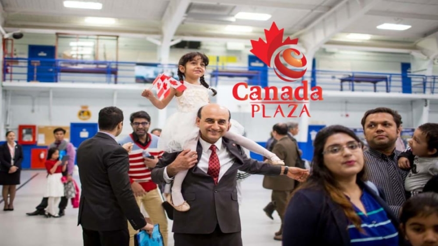 TORONTO, ON - MAY 2: Hadi Elhami, originally from Iran, carries his daughter, Arnika Elhami, on his shoulder during a citizenship ceremony held at the Royal Canadian Navy local reserve division HMCS York. 250 new Canadians took the oath on this day        (Carlos Osorio/Toronto Star via Getty Images)